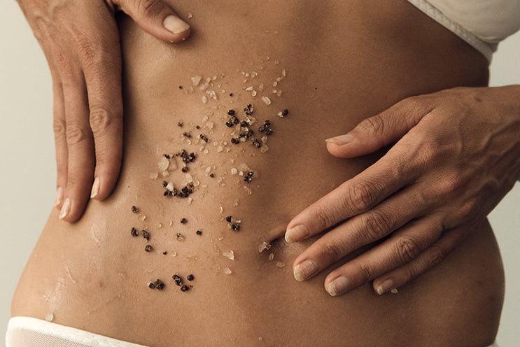 Woman receiving rock/salt body scrub